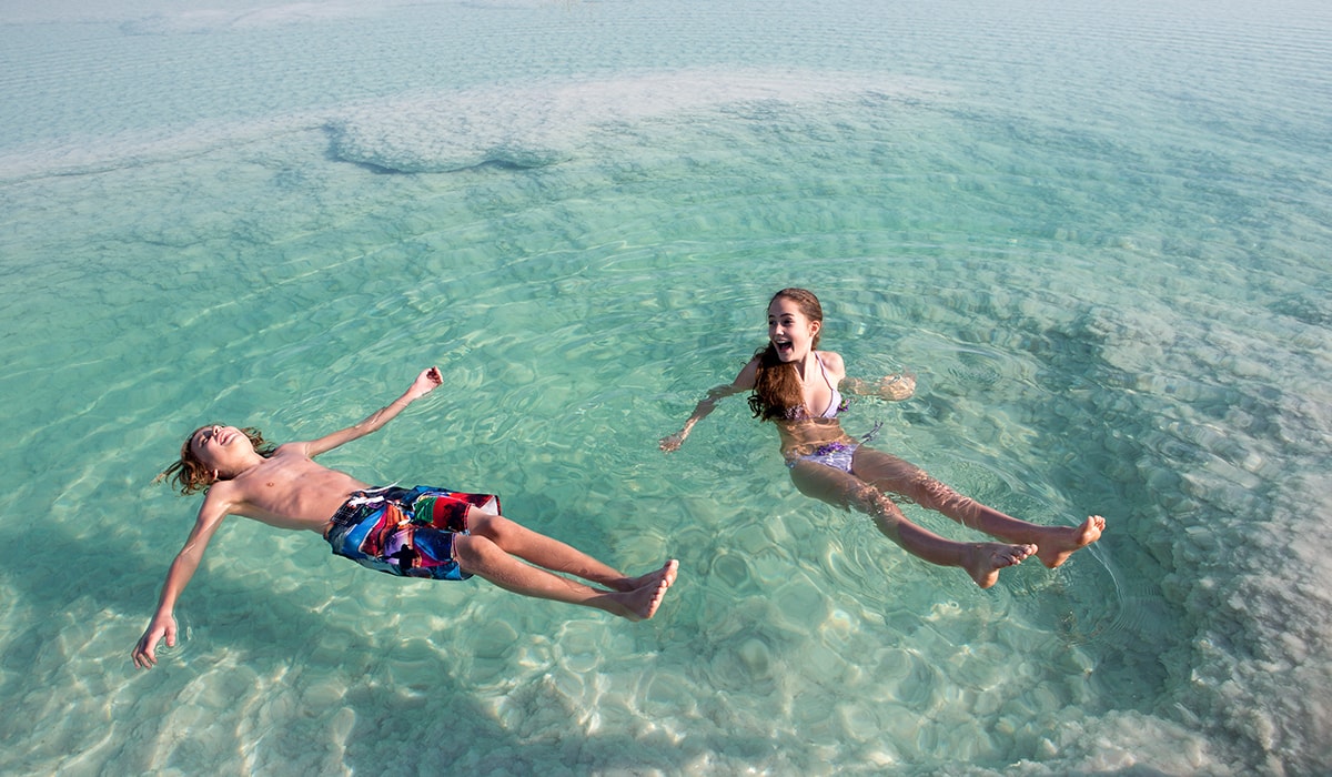 Children floating in the Dead Sea