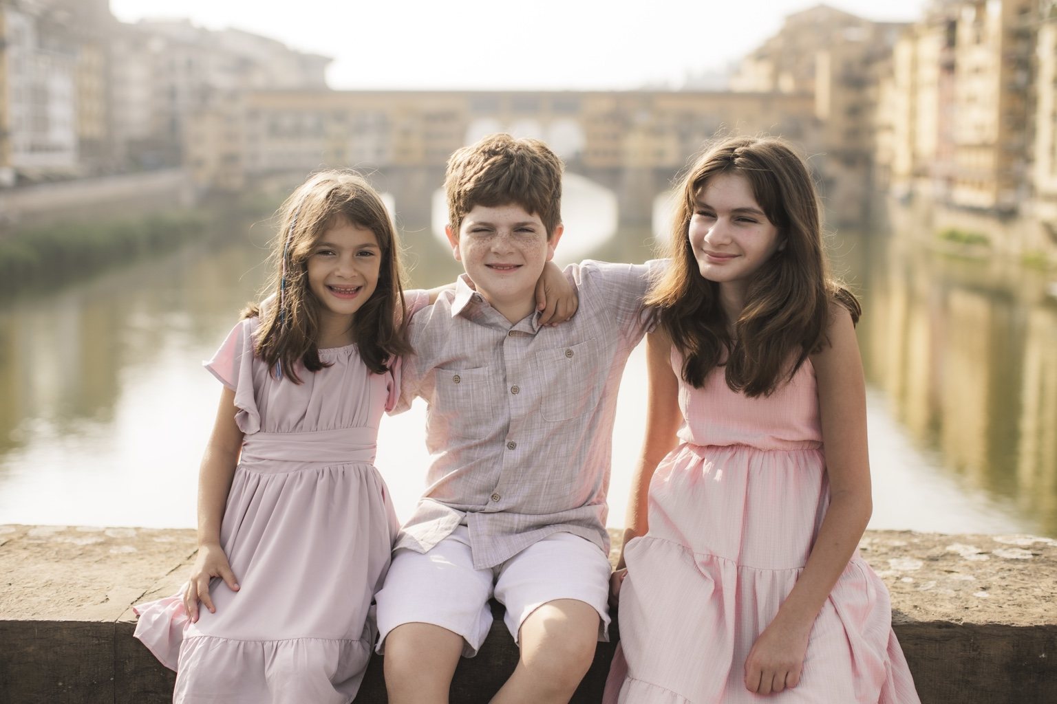 Three children hugging during a family photoshoot