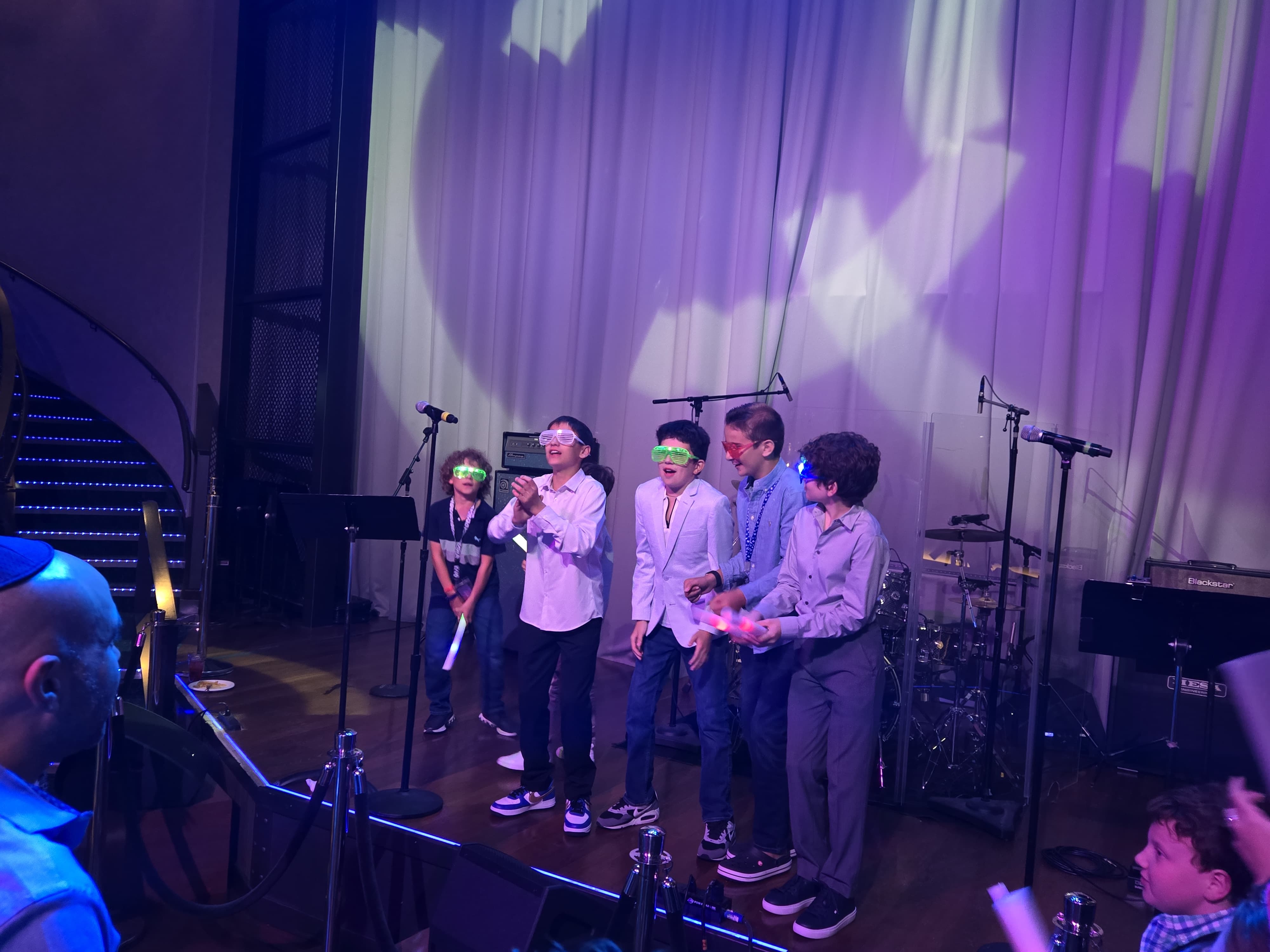 Kids celebrating on stage during a cruise mitzvah celebration